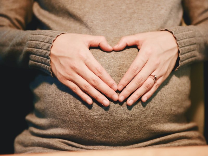 Patient supporting belly during prenatal hormone consultation